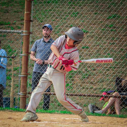 An Elkridge Hurricanes hitter starting his swing to hit a pitched ball.