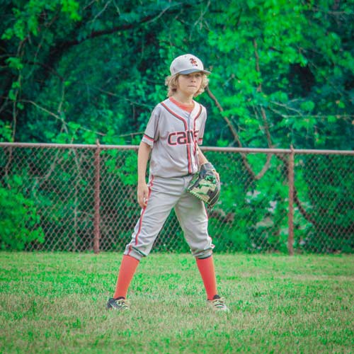 An Elkridge Hurricanes left fielder stands ready in the outfield.